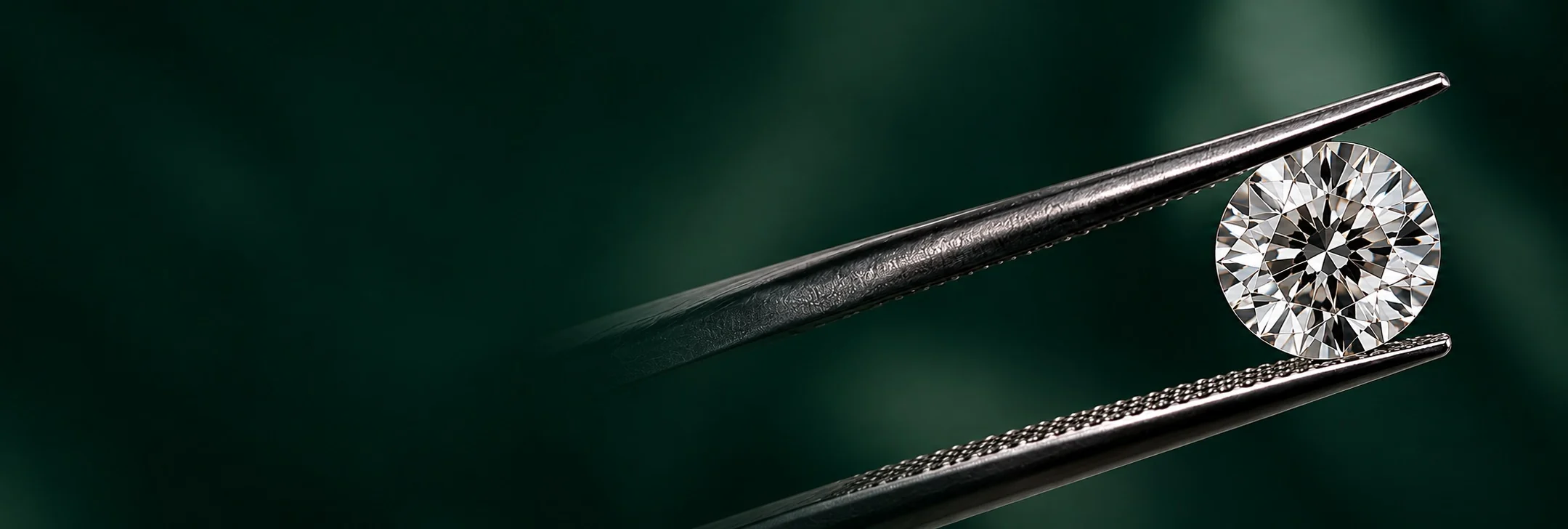 Brilliant-cut diamond held in tweezers